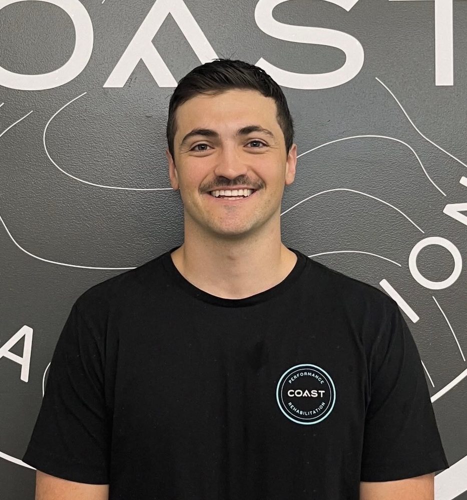 Sean Hase smiling in a black t-shirt